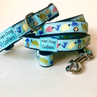 Dog collar and leash with sea-themed design of sea turtles and fish. Durable construction and materials with a seize proof stainless clip