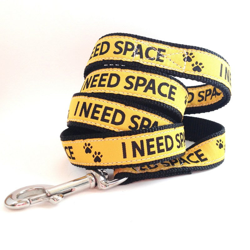 Yellow dog leash with 'I NEED SPACE' text, part of the Yellow Dog Project. Built or coastal adventures with durable marine materials and a seize proof stainless clip