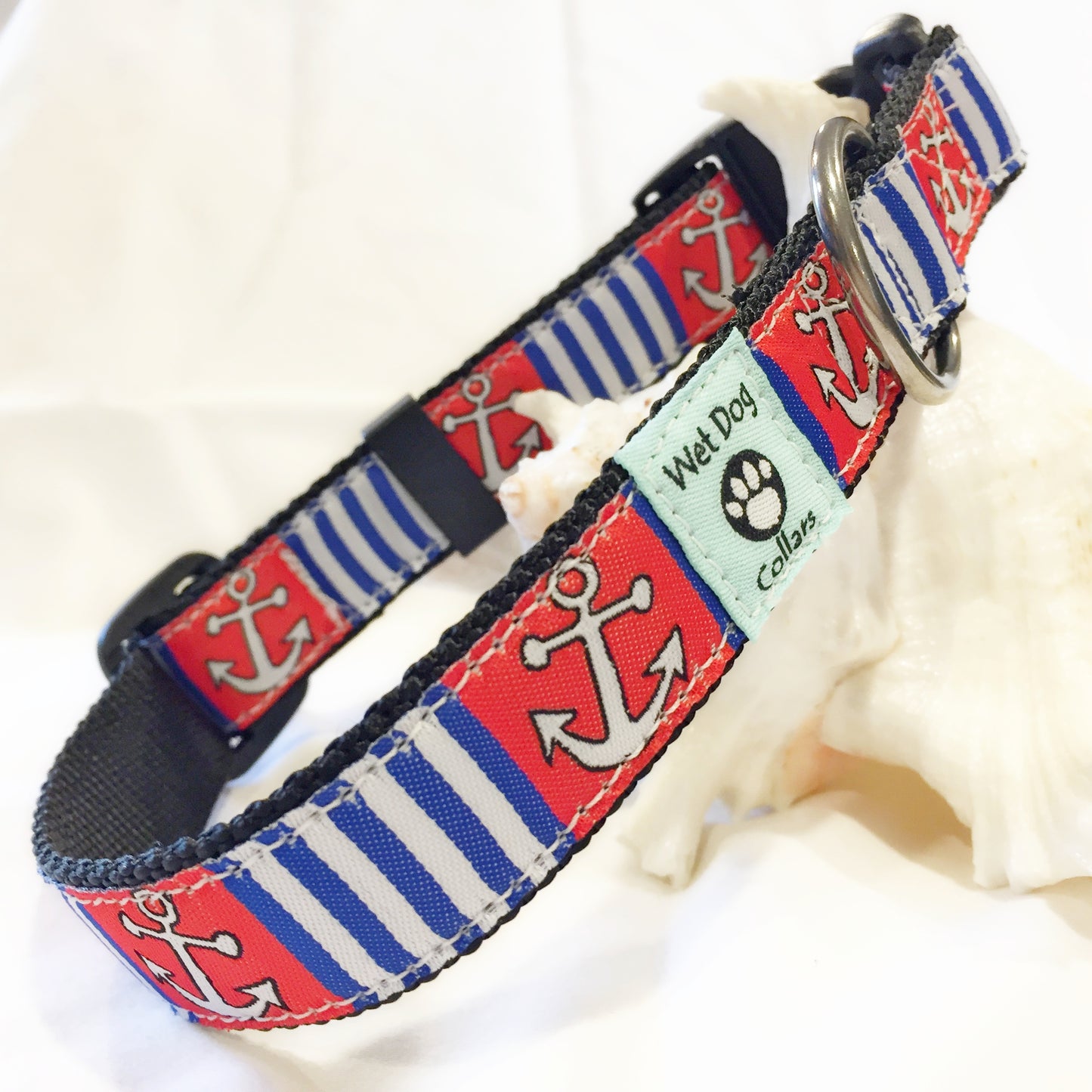 Nautical-themed dog collar with anchors and stripes on a white background for the salty dog