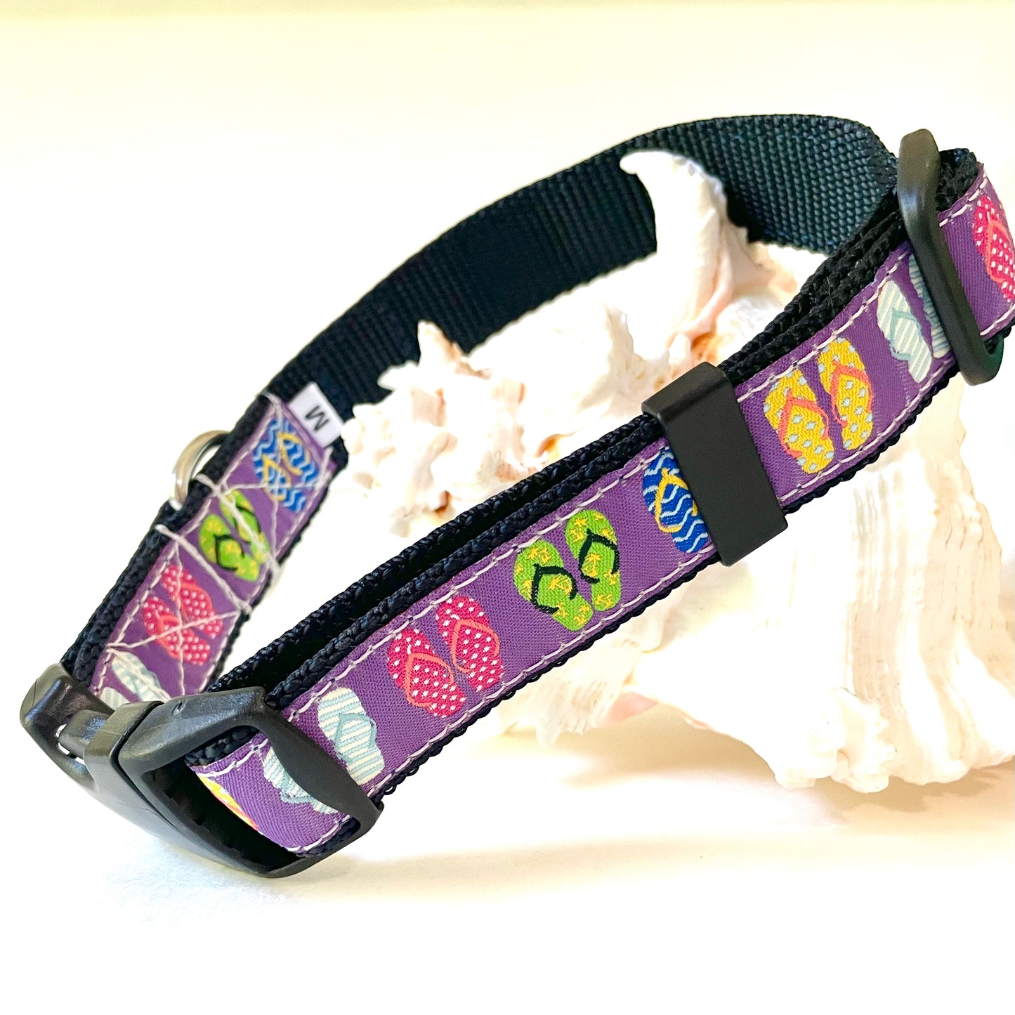 Colorful beach dog collar with flip flop design on purple background for saltwater with rust proof stainless hardware