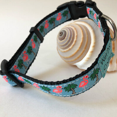 Dog collar with flamingo and palm tree pattern for saltwater use.