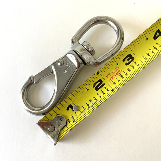 Metal swivel hook with measuring tape on a white background