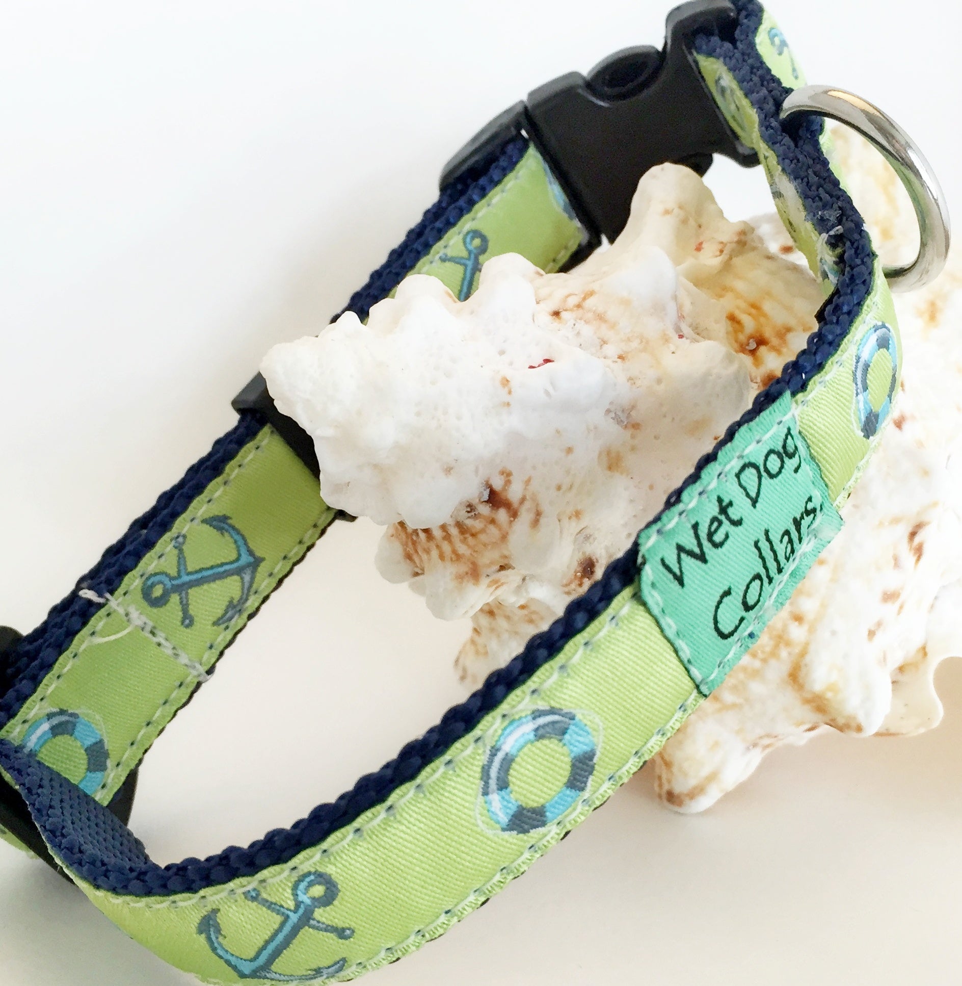 Green and blue dog collar with anchor pattern and saltwater materials for beach use