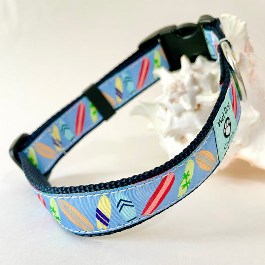A pet collar with a light blue background and a colorful surfboard pattern with rust proof metal for beach